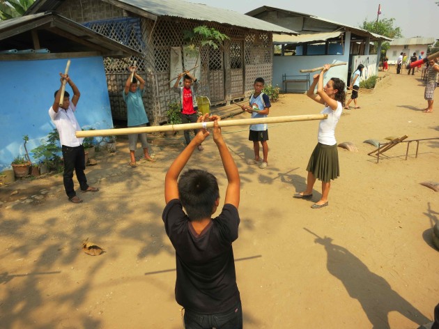 Students from schools and technical colleges learn how to teach workshops using different circus tools - here Sonja shows them how to work with simple bamboo staffs